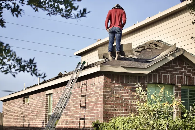 Professional roofer working on a residential roof in Atwoodville